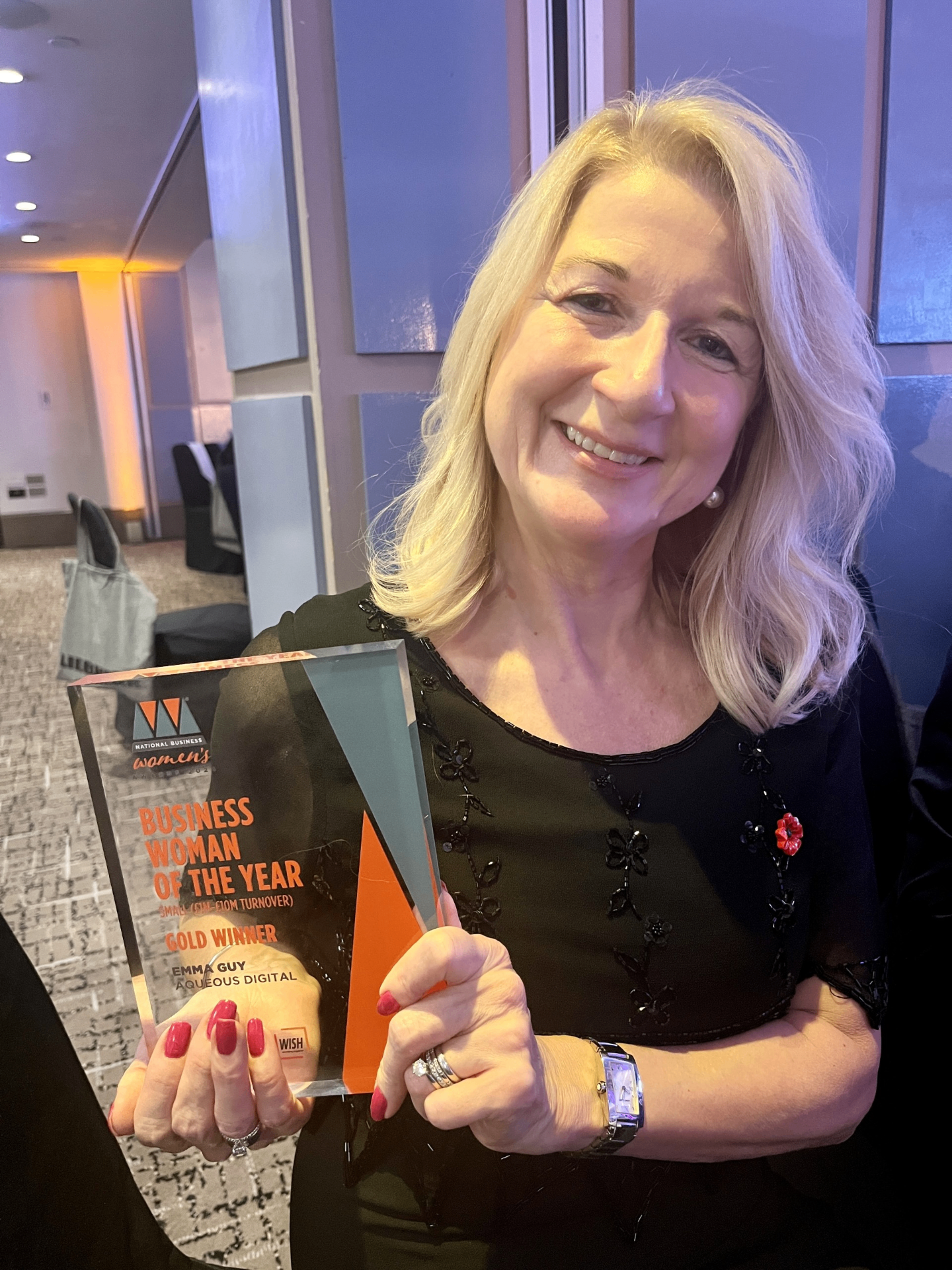 Emma Guy holding the Gold Winner trophy for Business Woman of the Year at the National Business Women's Awards